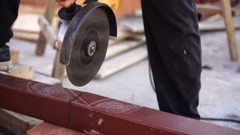 worker cutting metal with grinder