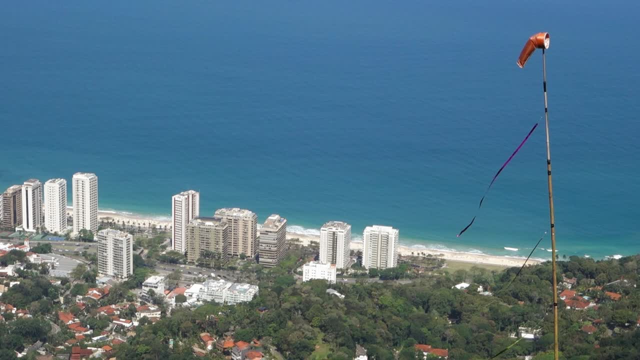 Modern Buildings At The Sea Coast With Windsock In Foreground. Rio de Janeiro In Brazil In Summer. high angle