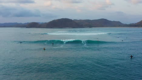 surfing at sunset at the surf spot don don in gerupuk, lombok