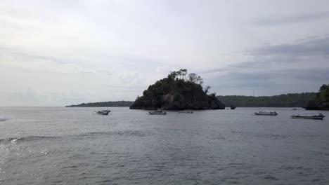 Calmer-aerial-view-flight-fly-forwards-drone-shot-to-the-rock-island