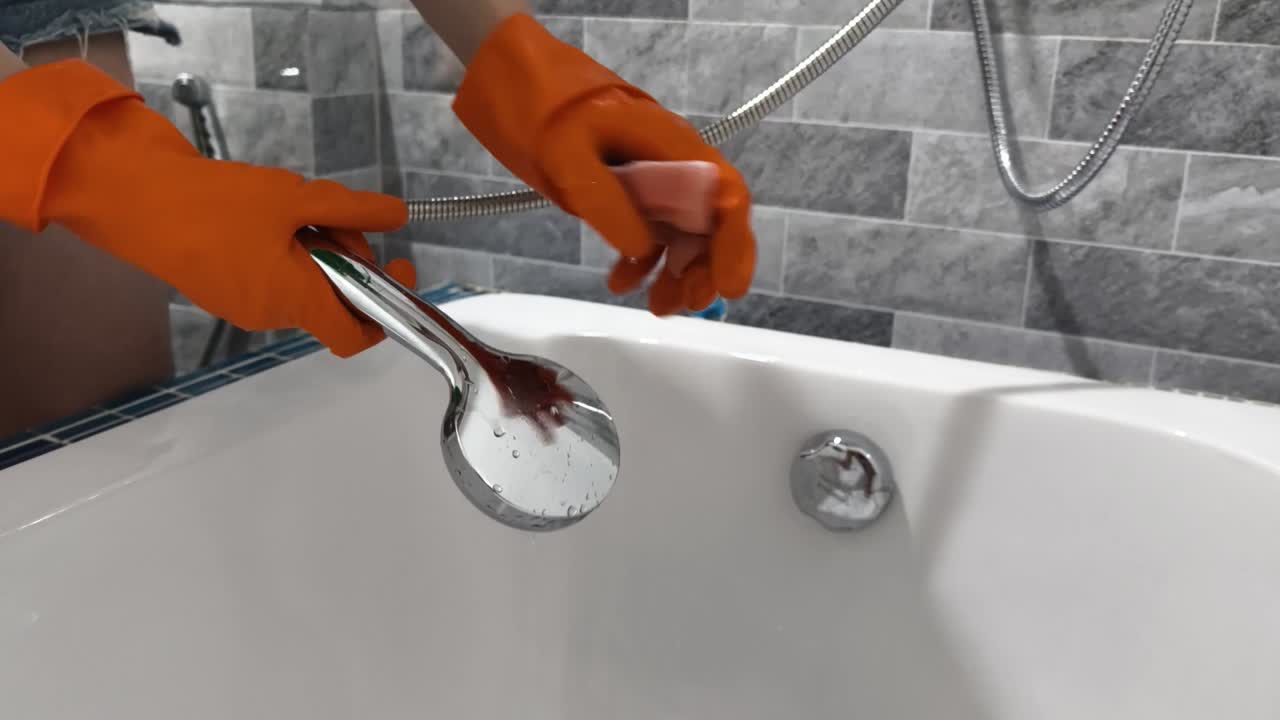 Cleaning a shower head in a bathtub