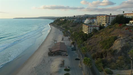 Aerial-view-over-an-empty-beach-in-San-Clamente,-California-at-sundown