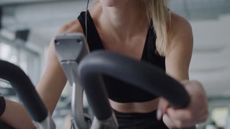 Handheld-view-of-sporty-woman-working-out-with-exercise-bike