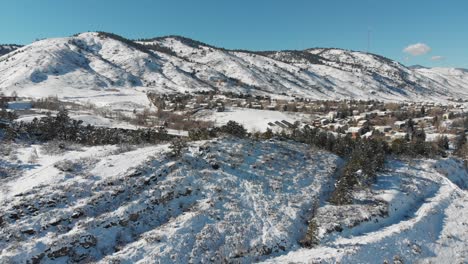 a slow flight over a golden colorado after a spring snowstorm