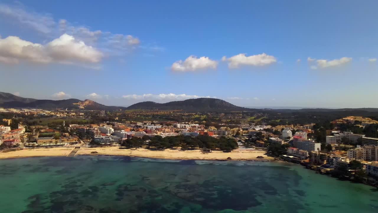 Discover the stunning coastline of Santa Ponsa in Mallorca with beautiful sandy beaches and crystal-clear waters. Enjoy the scenic views of the town and surrounding mountains under clear blue skies.