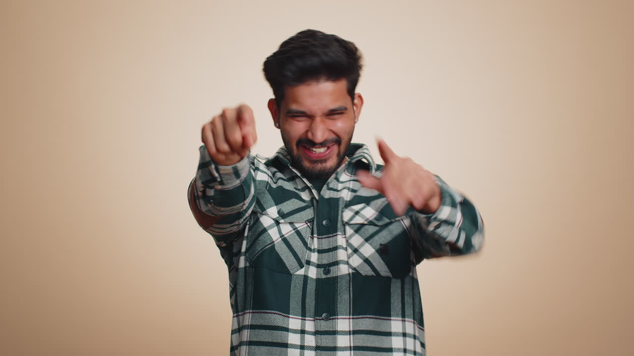 Amused smiling cheerful indian man laughing out loud funny ridiculous joke anecdote bullying