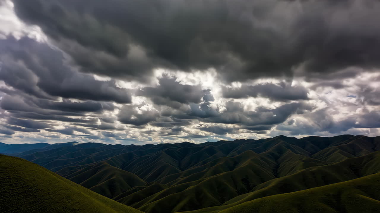 Green Mountain Range Under Dramatic Clouds