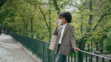 Businesswoman-standing-holding-coffee-cup-takeaway.-woman-relax-on-city-street