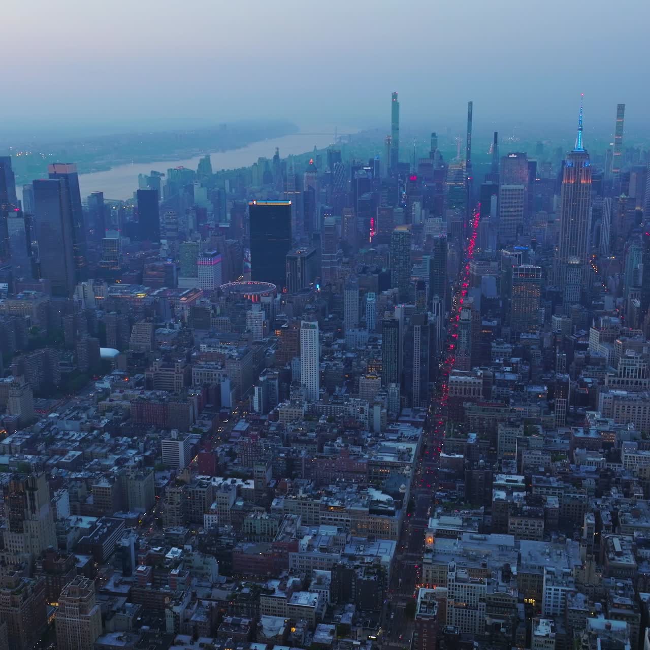 Fascinating panorama of splendid New York in the coming evening. Blue fog covering the metropolis at dusk. Aerial view