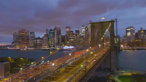 Magnificent-Beautiful-Dramatic-Aerial-Of-The-Brooklyn-Bridge-At-Night-In-New-York-City