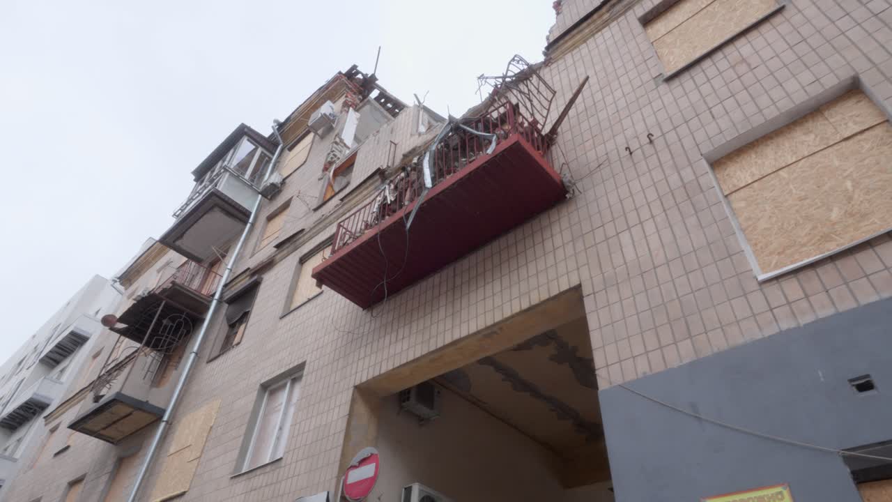 Damaged Residential Building with Collapsed Balconies and Boarded Windows in Ukraine