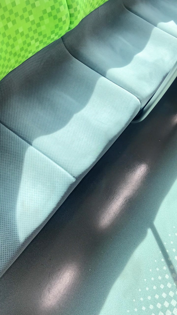 POV phone reel UGC style vertical video of Japanese train seats in the sun during ride or commute to work. Travel vlog social media by content creator traveling in Japan and Asia. Taking train metro