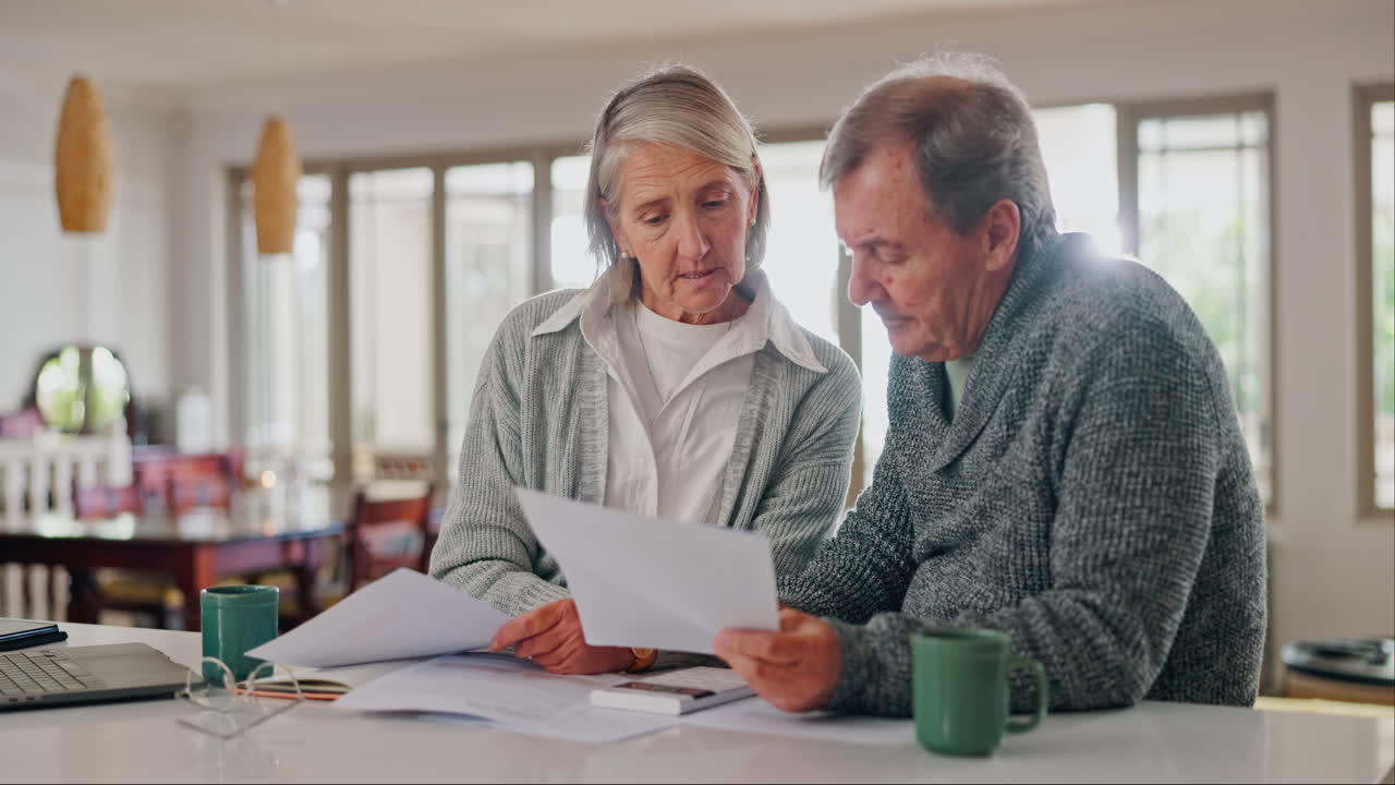 Senior couple, laptop and calculator with bills
