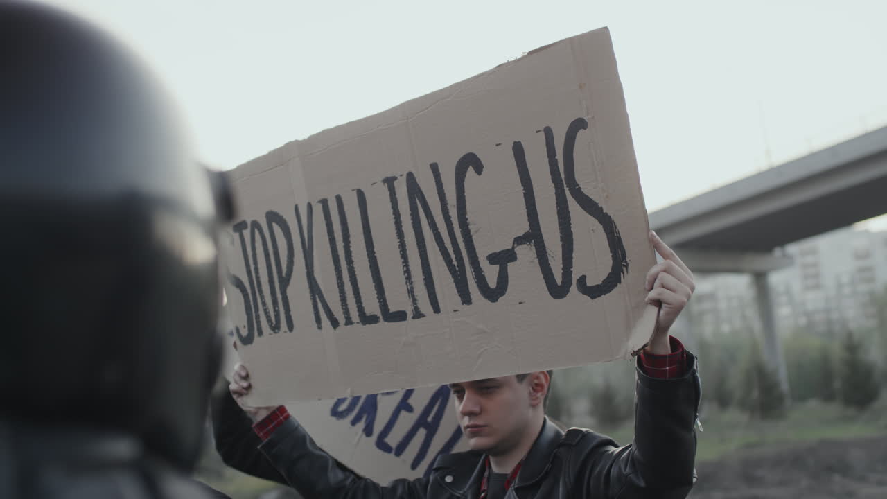 Protesters holding signs