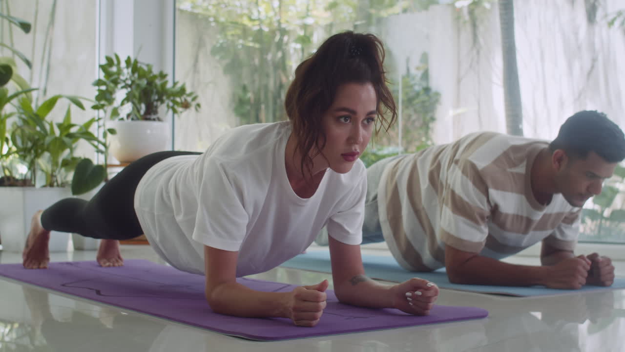 Girl and Her Boyfriend Practicing Plank Exercise on Mats on Floor at Home