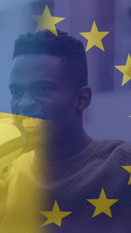 animation of flag of ukraine and european union over african american male protester