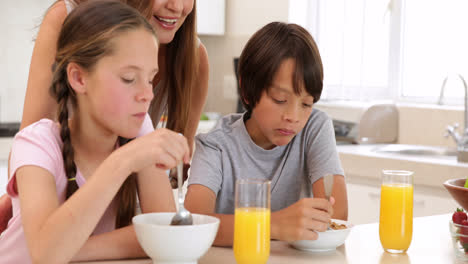 brother and sister eating cereal together