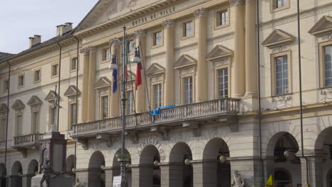 a close-up view of the large neoclassical-style building with a porch of the town hall, aosta valley, italy