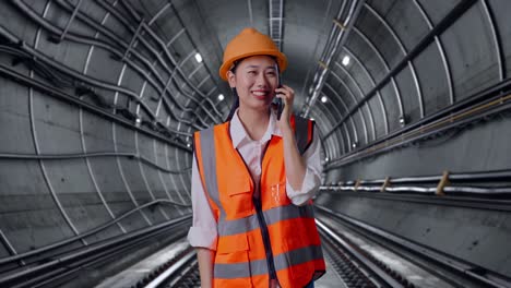 female engineer talking on phone in a tunnel