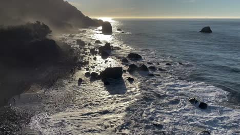 tilt pan shot of waves crashing against the rugged rock along lands end in san francisco, california