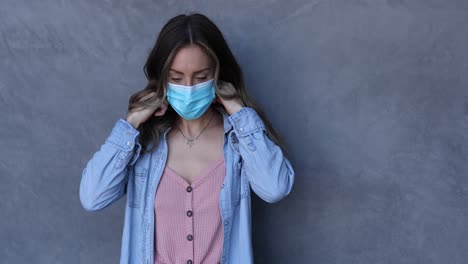 a cleared female nurse or woman with mask puts on a mask during the covid19 coronavirus pandemic epidemic 1