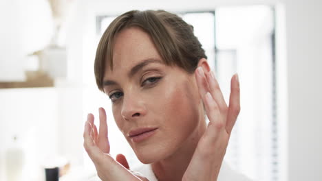 Middle-aged-Caucasian-woman-touches-her-temples-gently