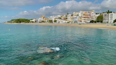 Platja-de-les-Barques-sea-field-Maresme-Barcelona-Mediterranean-coast-plane-close-to-turquoise-blue-transparent-water-beach-without-people