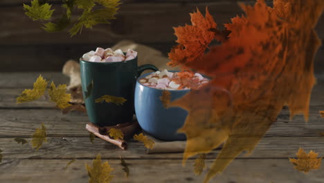 animation of leaves over mugs with cocoa on wooden background