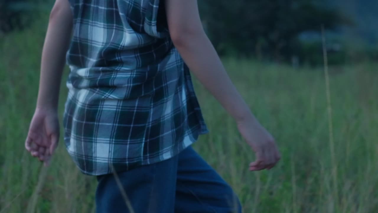 Cropped View Of A Young Woman Walking Through Rural Fields. Slow Motion Shot
