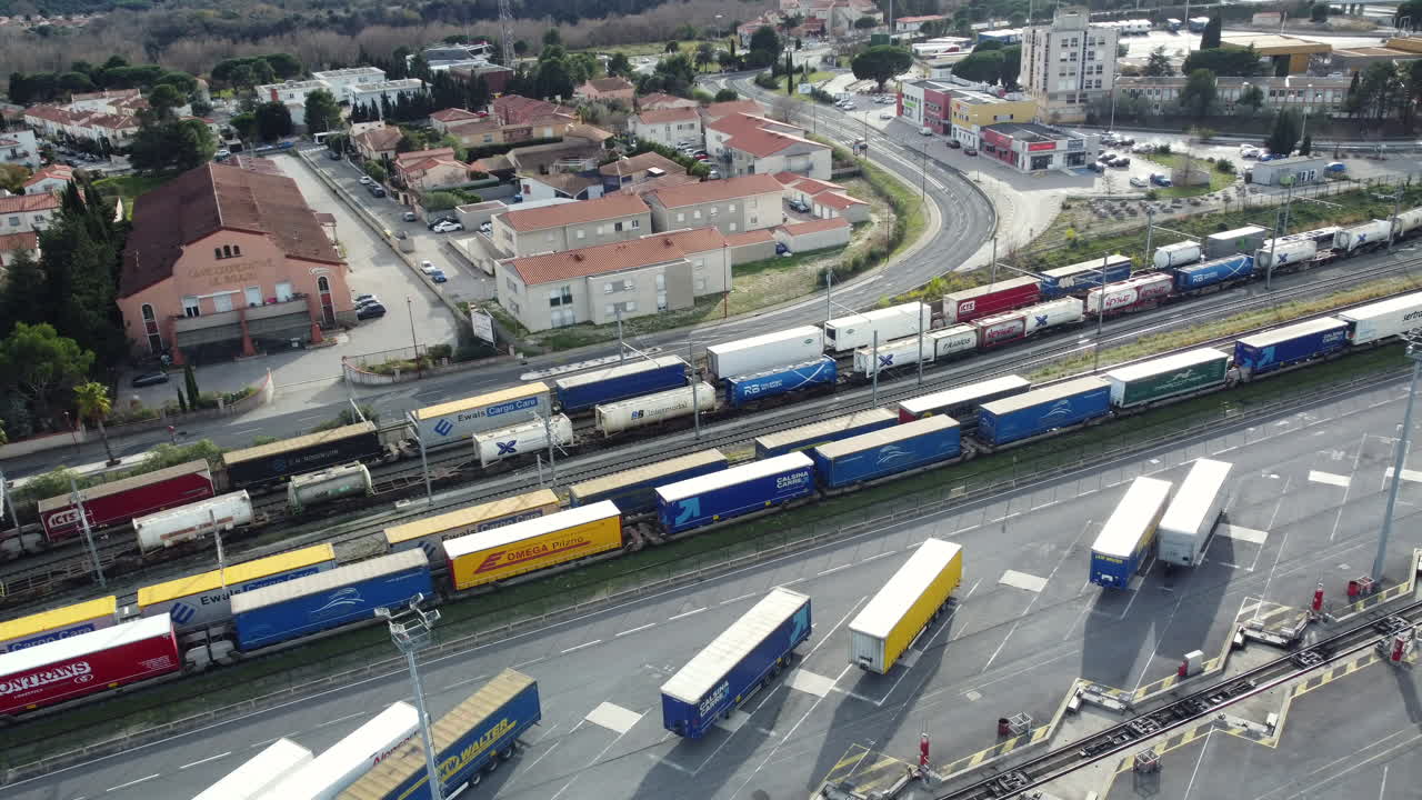 Aerial View of Freight Train and Trucks at a Depot in a French Town