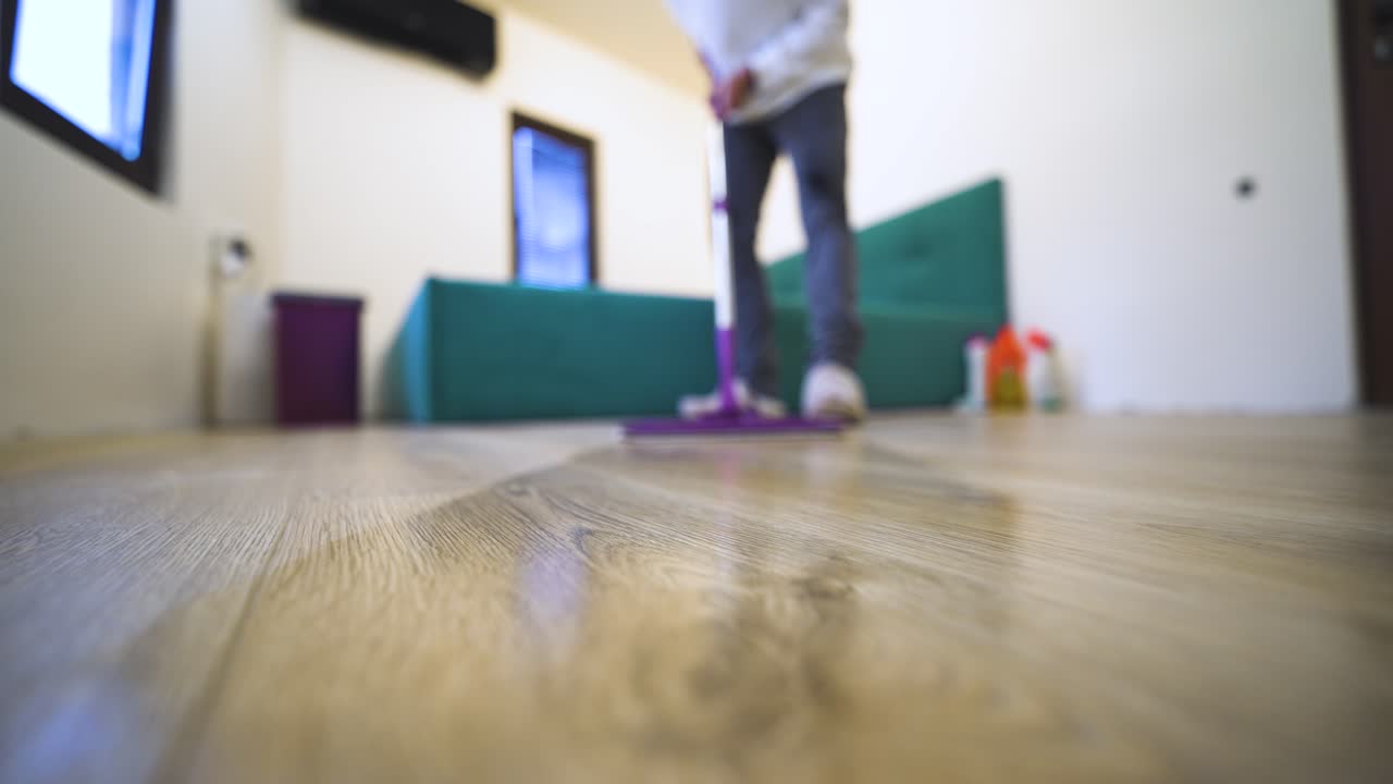 First-person domestic scene showing woman doing housework, mopping the floor, and maintaining a clean home