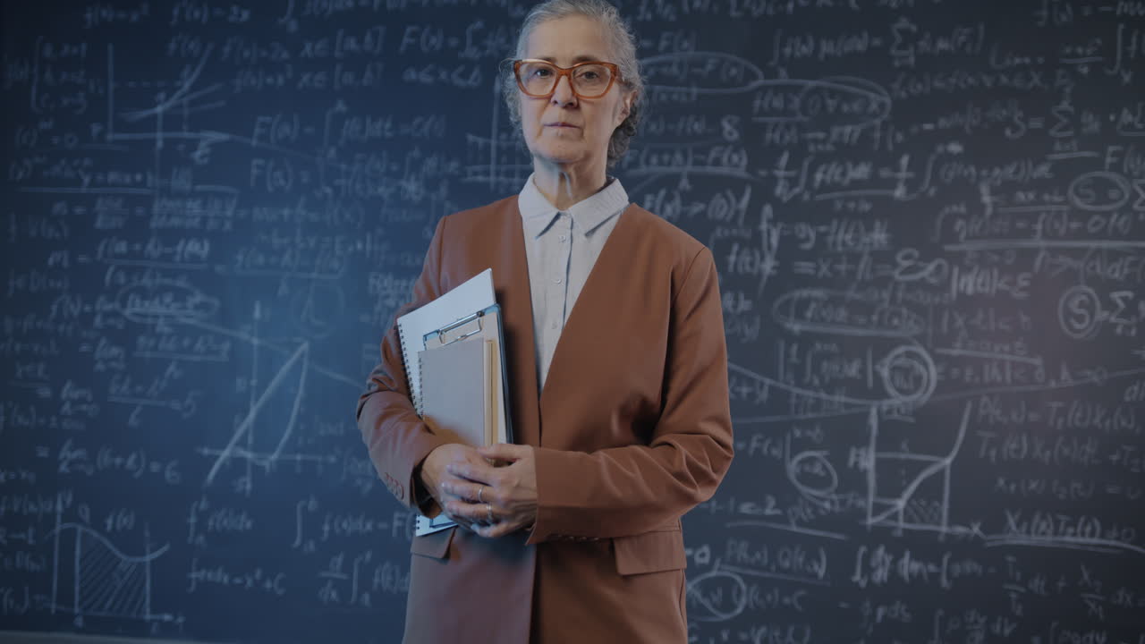 Teacher in front of a chalkboard filled with math equations