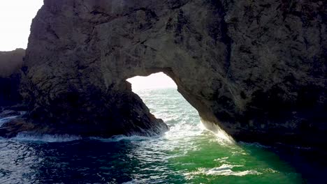 a drone slowly approaches a archway and then flies through.