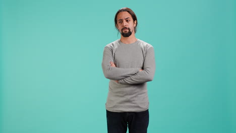 grumpy man crossing arms, feeling upset by events