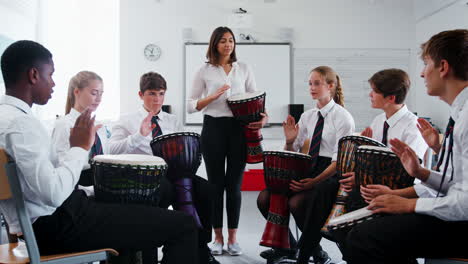 estudiantes adolescentes que estudian percusión en la clase de música