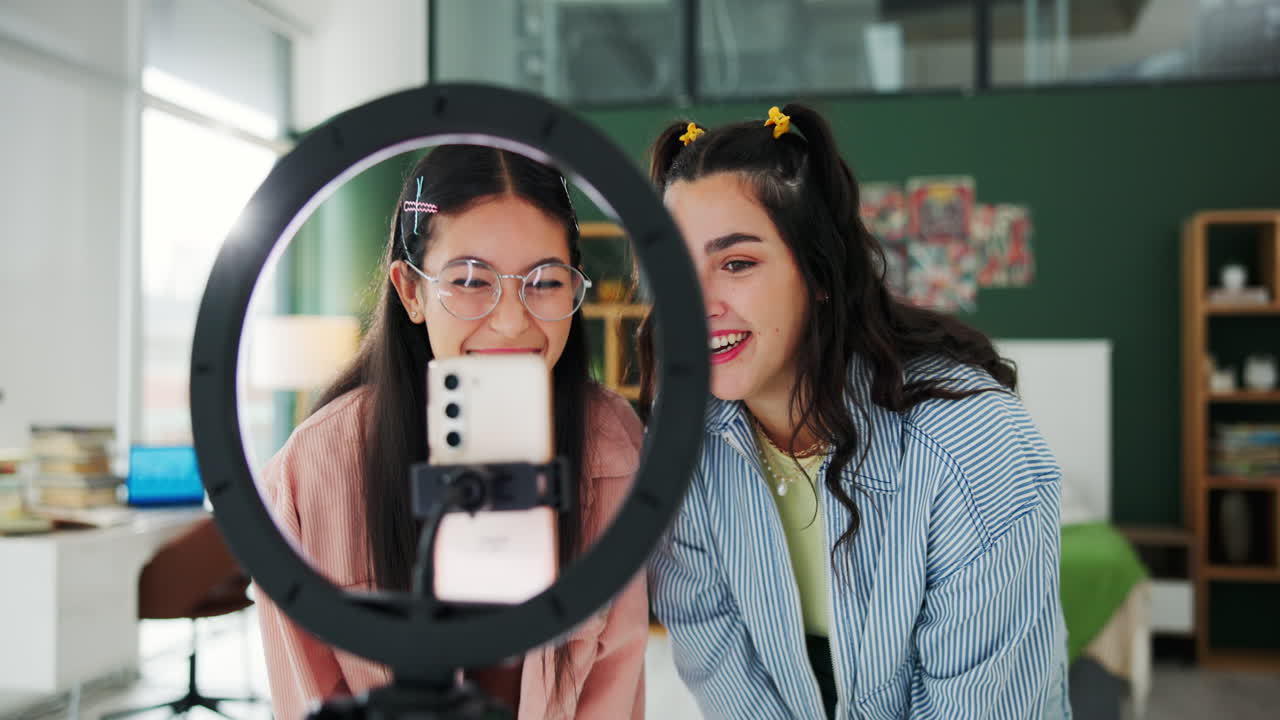Two women recording a video with a ring light and smartphone