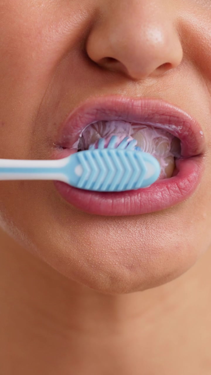 Close-up of a Woman Brushing Her Teeth