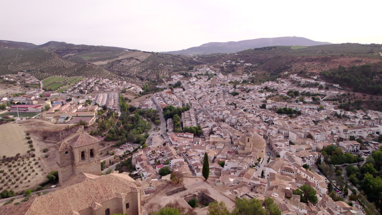 Flying from behind the hill of Montefrio towards the village, Spain