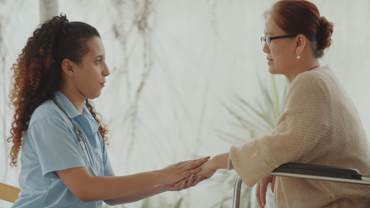 Nurse providing support to an elderly woman