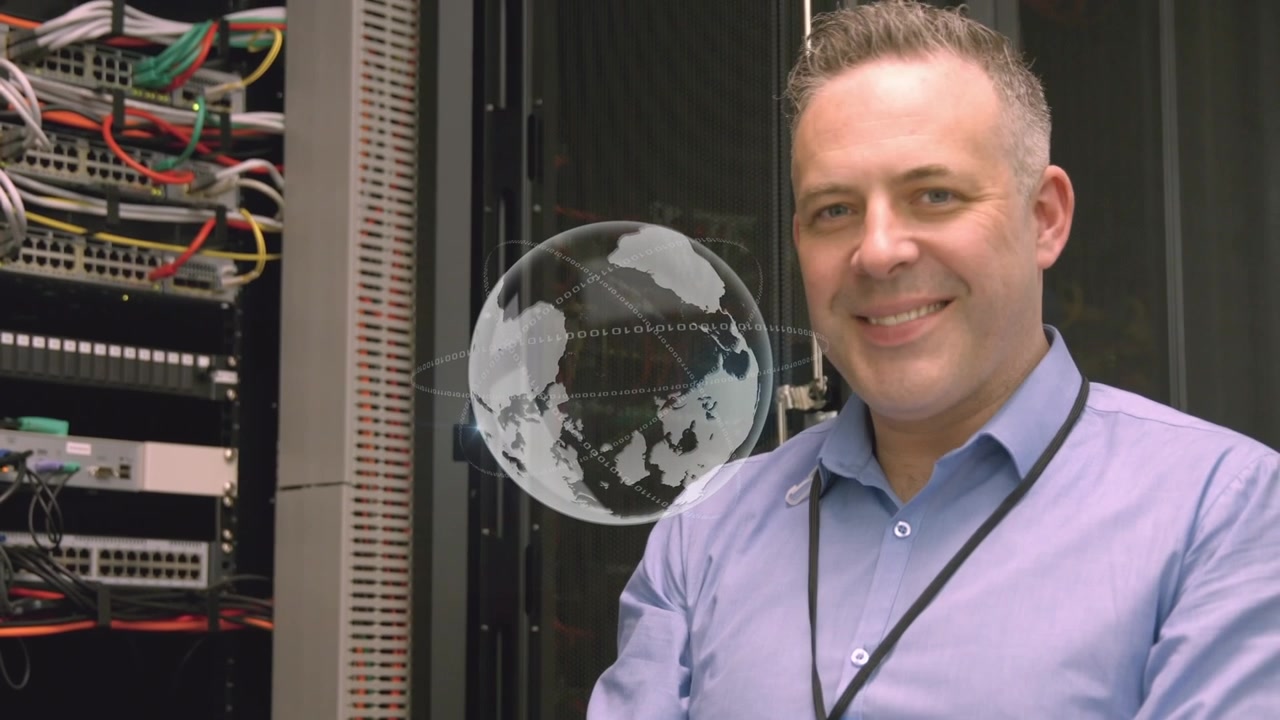 Animation of globe over caucasian businessman in server room