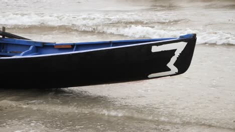 Closeup-of-taped-number-three-on-currach-boat-canoe,-galway-ireland