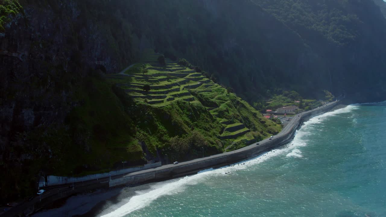 Coastal Road Winding Through Terraced Hills