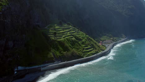 coastal road winding through terraced hills