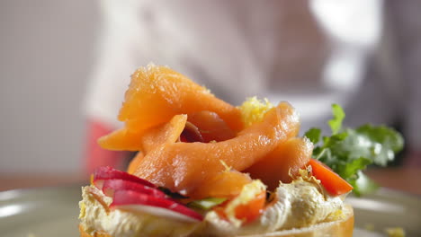 Close-up-of-lemon-zest-drops-on-a-smoked-salmon-bagel-with-cream-cheese