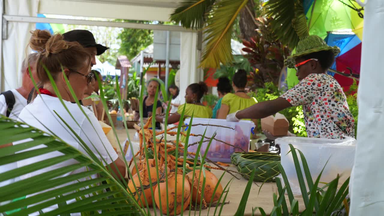 Mahe, Seychelles, 22.09.24, Tourism Festival week 2024, in town Victoria, tourist buying local chips in kiosk 30fps 1