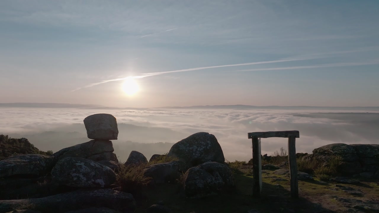 Cotton Like Foggy Sky On A Hill With Ruins And Boulders At Sunset