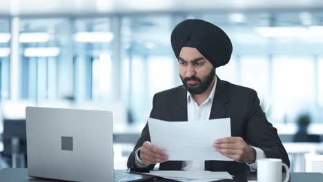 Angry-Sikh-Indian-businessman-working-on-Laptop