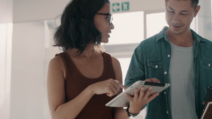 Man, woman and team walking with tablet in office