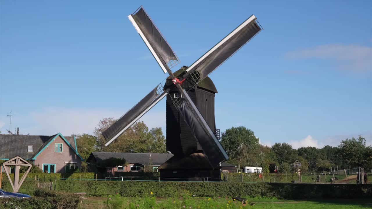 Black windmill, whispering secrets to the sky, each rotation silent incantation