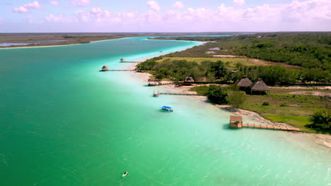 rotating drone shot of piers and docks on turquoise waters in bacalar mexico